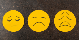 A group of three sad emoji faces