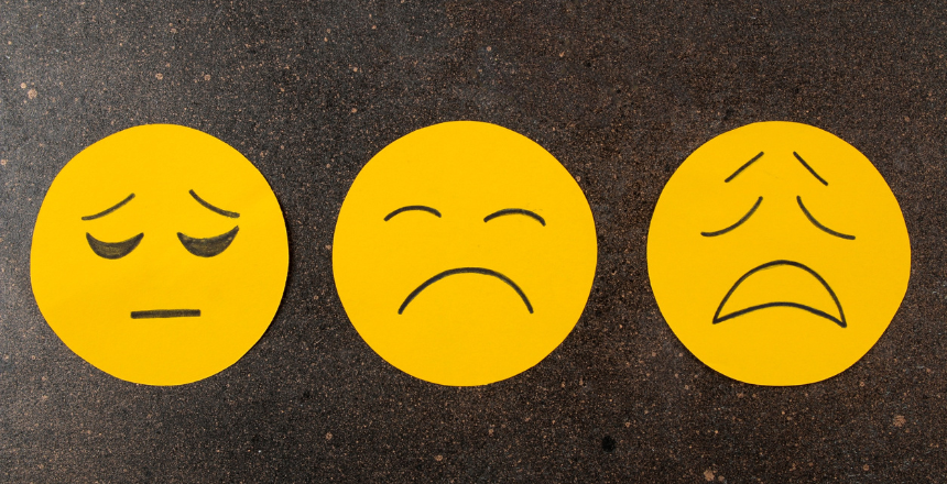 A group of three sad emoji faces