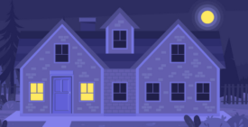 House with darkened windows and two lighted rooms