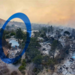 Aerial view of a fire-ravaged hillside in Altadena after the Eaton Fire, with blackened trees and ash-covered foundations surrounding a single intact, light-colored house still standing amid widespread destruction; smoke hangs in the sky.