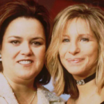 Rosie O'Donnell and Barbra Streisand smiling together at an event in November 1997, both in evening wear, standing close with arms around each other.